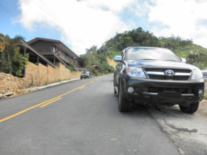 car parked on hill stuck in park